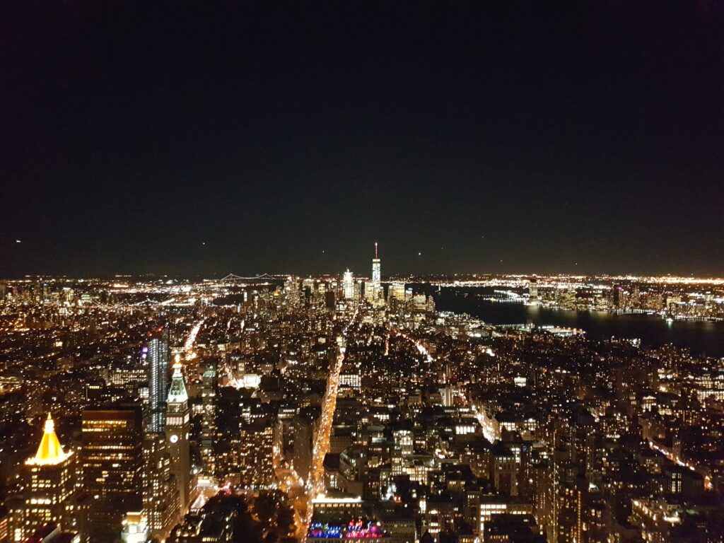 View from the Empire State Building at Night with planes landing